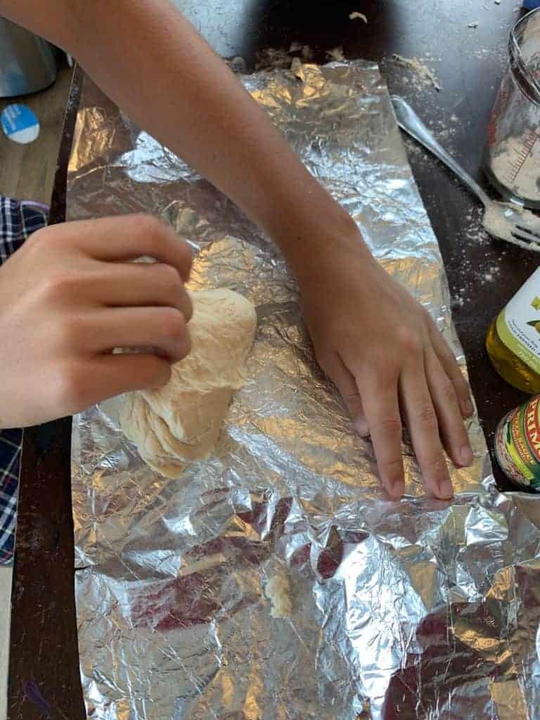 Laying dough on tin foil.