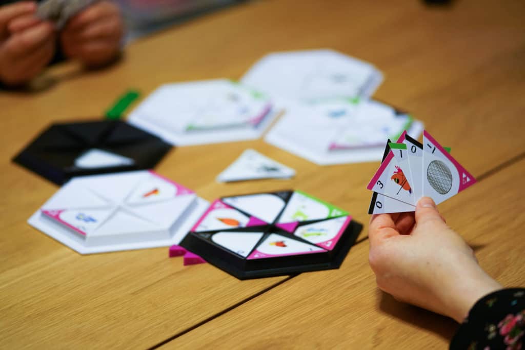 People playing the tabletop game Nunami.
