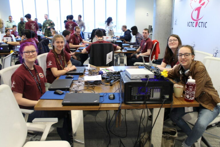 Team Falcon tech are sitting at a table at a competition.
