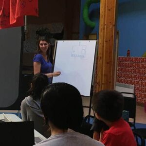 An instructor drawing on a whiteboard.