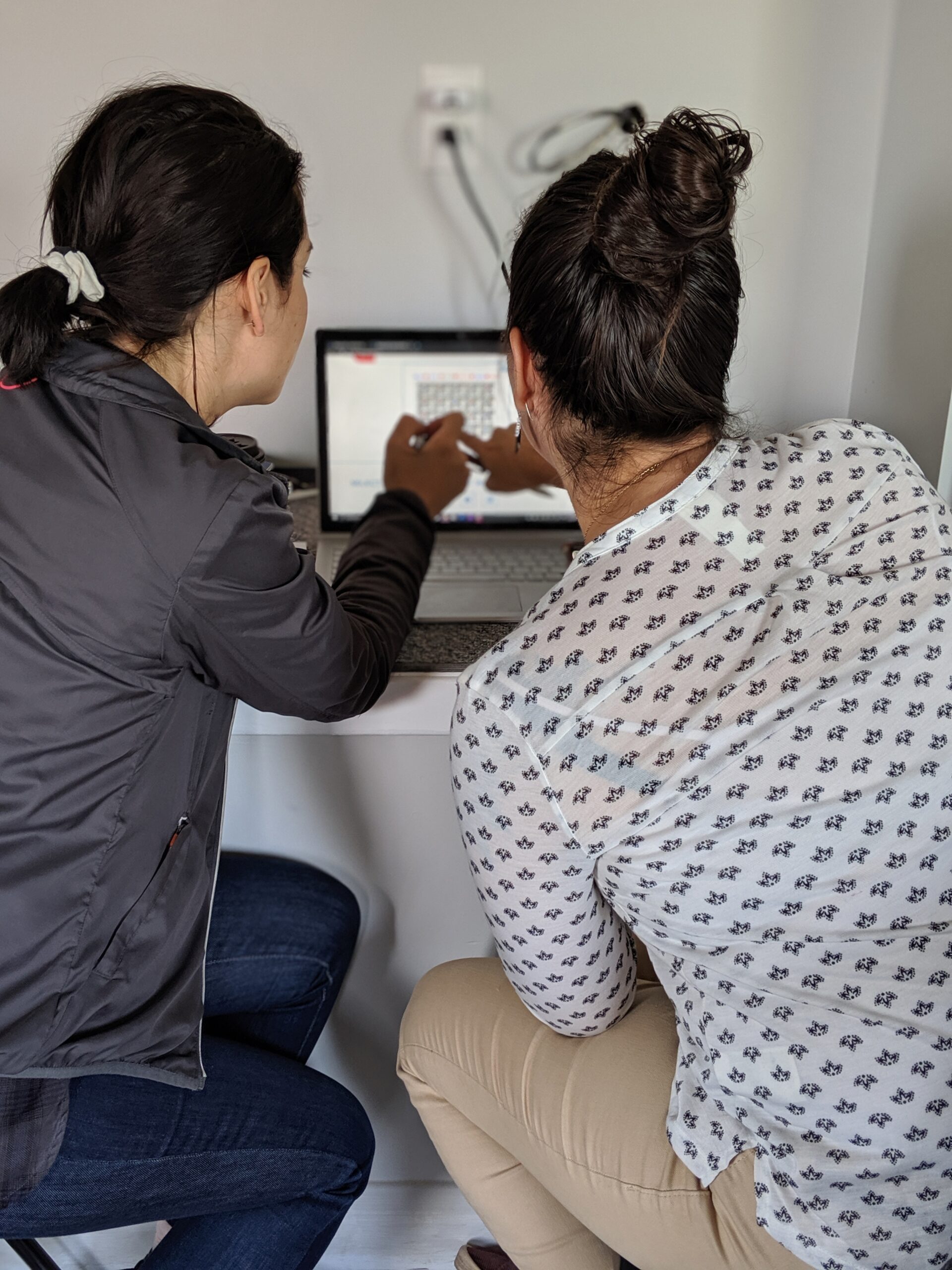 Adults looking at computer