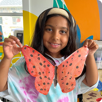 STEM learner holding hand painted butterfly STEM learner holding hand painted butterfly
