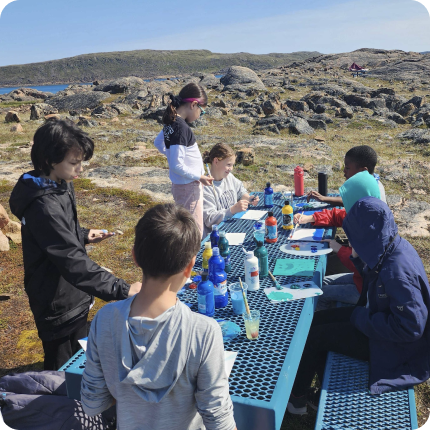 Group of learners painting outdoors