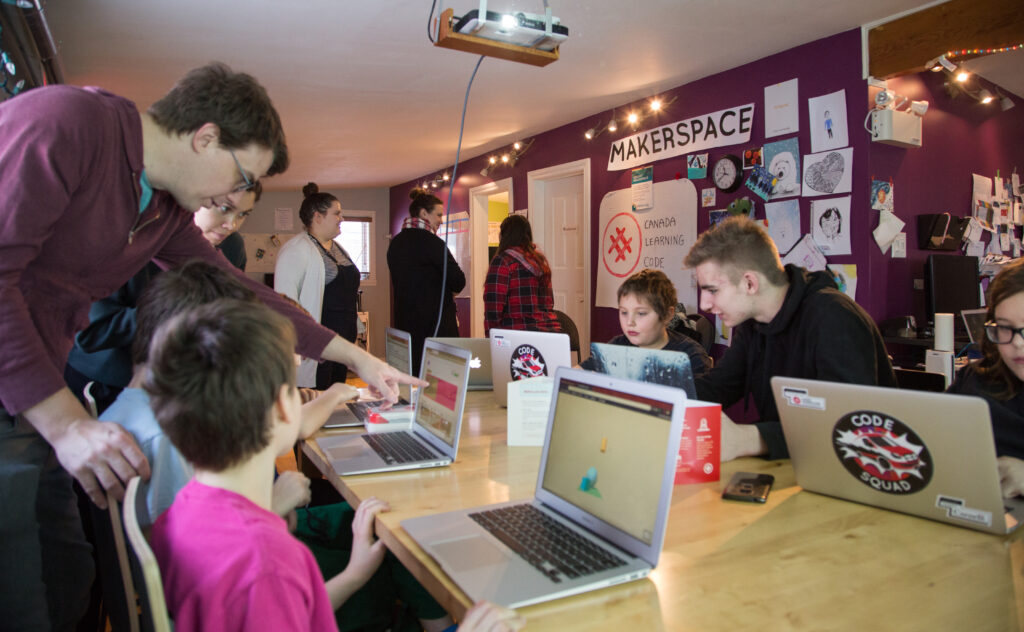 Students working on computers in the QIaluit Makerspace during Code week 2018.