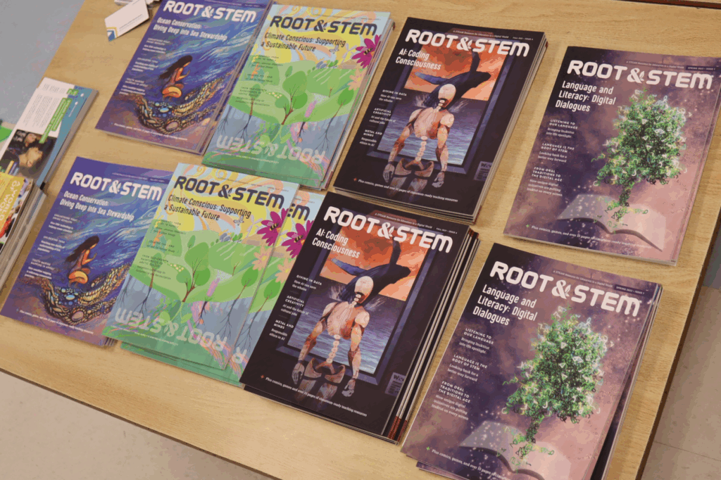 Eight neatly stacked piles of four different issues of the Root & STEM magazine on display on a wooden table.
