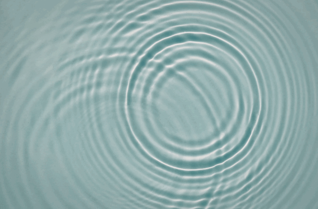 A water ripple on a light blue background.