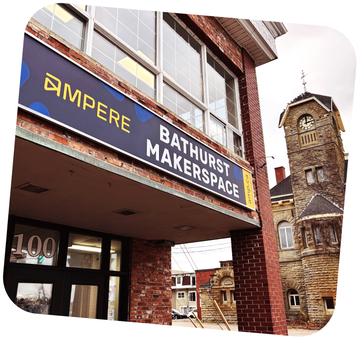 The front of the Bathurst Makerspace. A blue and yellow sign that reads "Ampere - Bathurst Makerspace" is above the entrance.