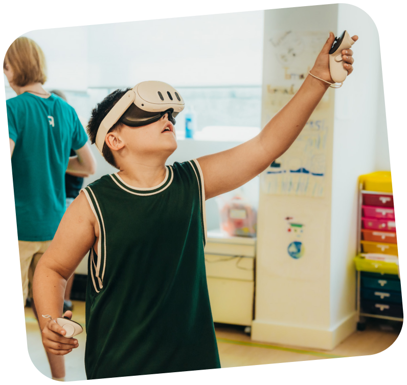 A young learner is using a VR machine to learn STEAM education. They have the headset on and are reaching upwards.