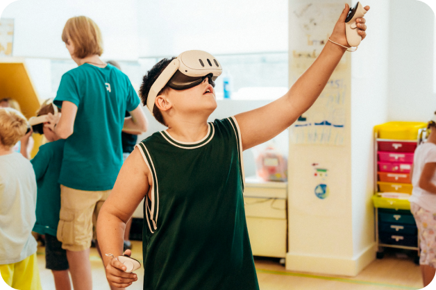 A young learner is using a VR machine to learn STEAM education. They have the headset on and are reaching upwards.