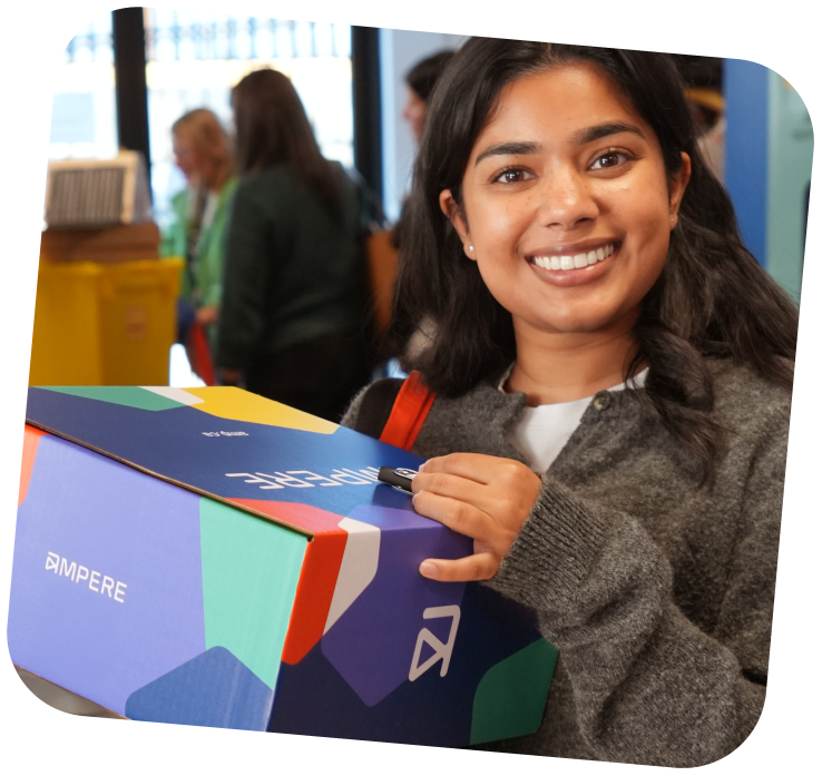 An educator holding a branded Ampere box.
