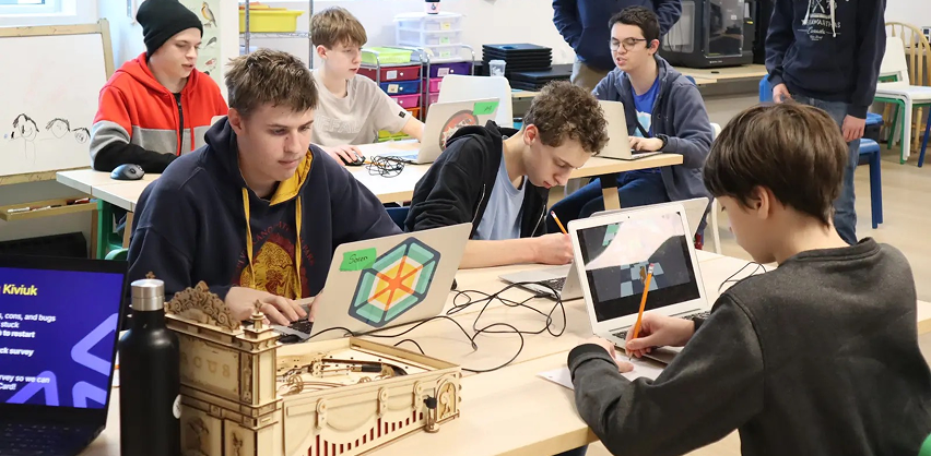 Students learning digital skills on laptops in the Lindsay Makerspace.