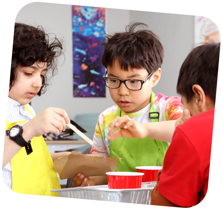 Three young learners working together.