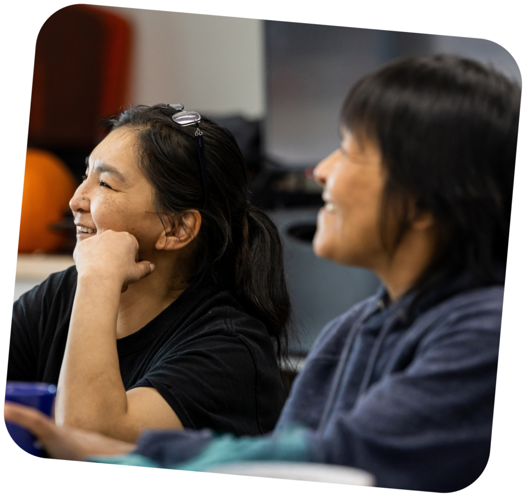 Two-Inuk-women-smiling-while-attending-a-workshop